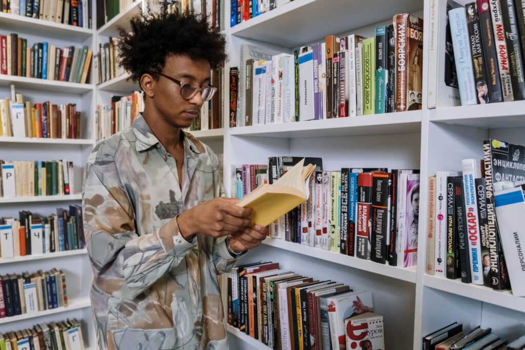 Boy reading book in library