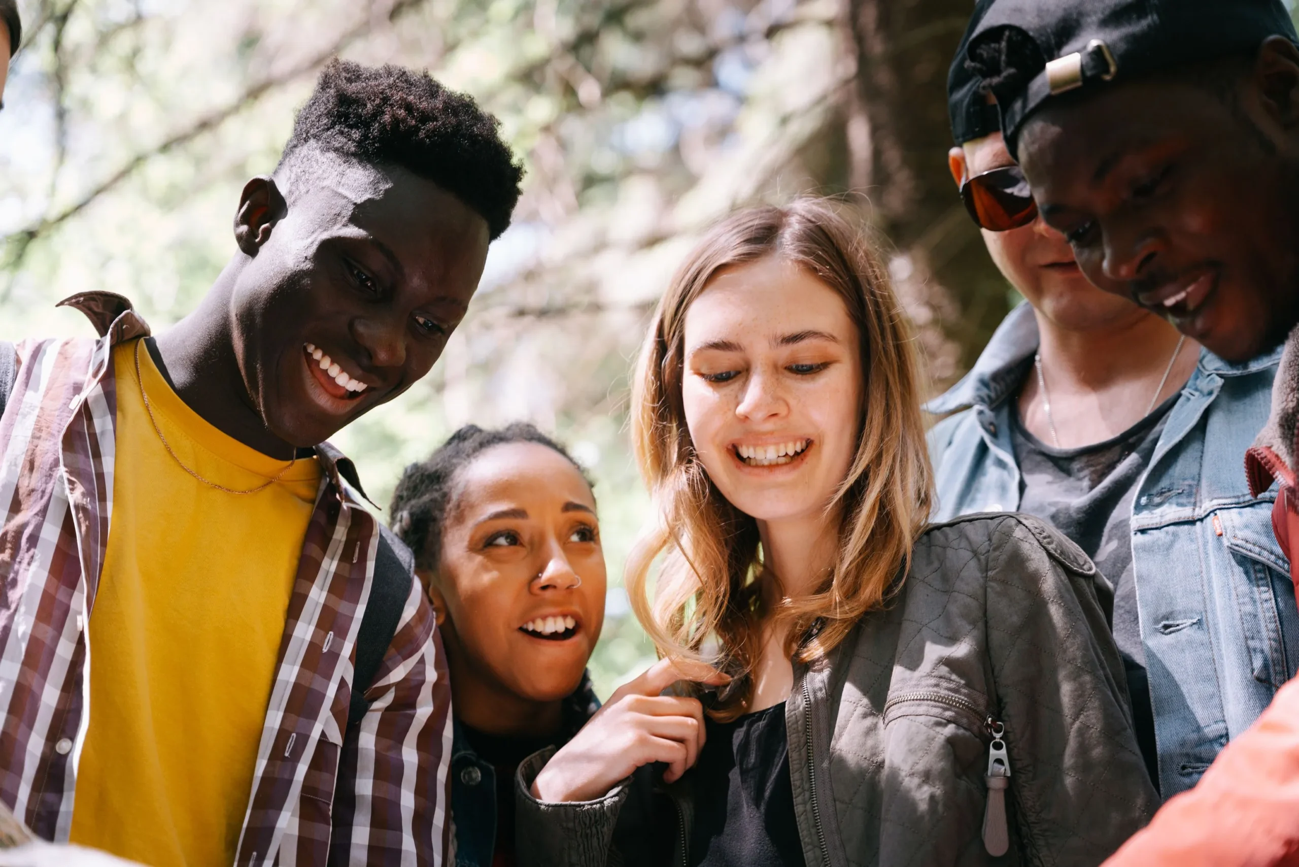Group of young friends socialising outdoors, reflecting the private communities discussed in dark social and the cosy web
